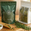 茶叶包装保质期验证场景,铝箔自立茶叶包装袋与检测记录表、取样茶叶放在一起