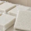 真空米砖包装袋成品,透明袋内大米被压成紧实的砖形,侧面可见压花纹理与封边结构